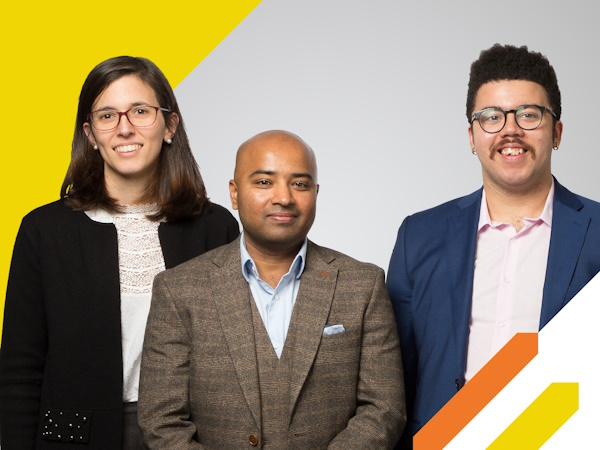 three people standing against a graphic yellow background
